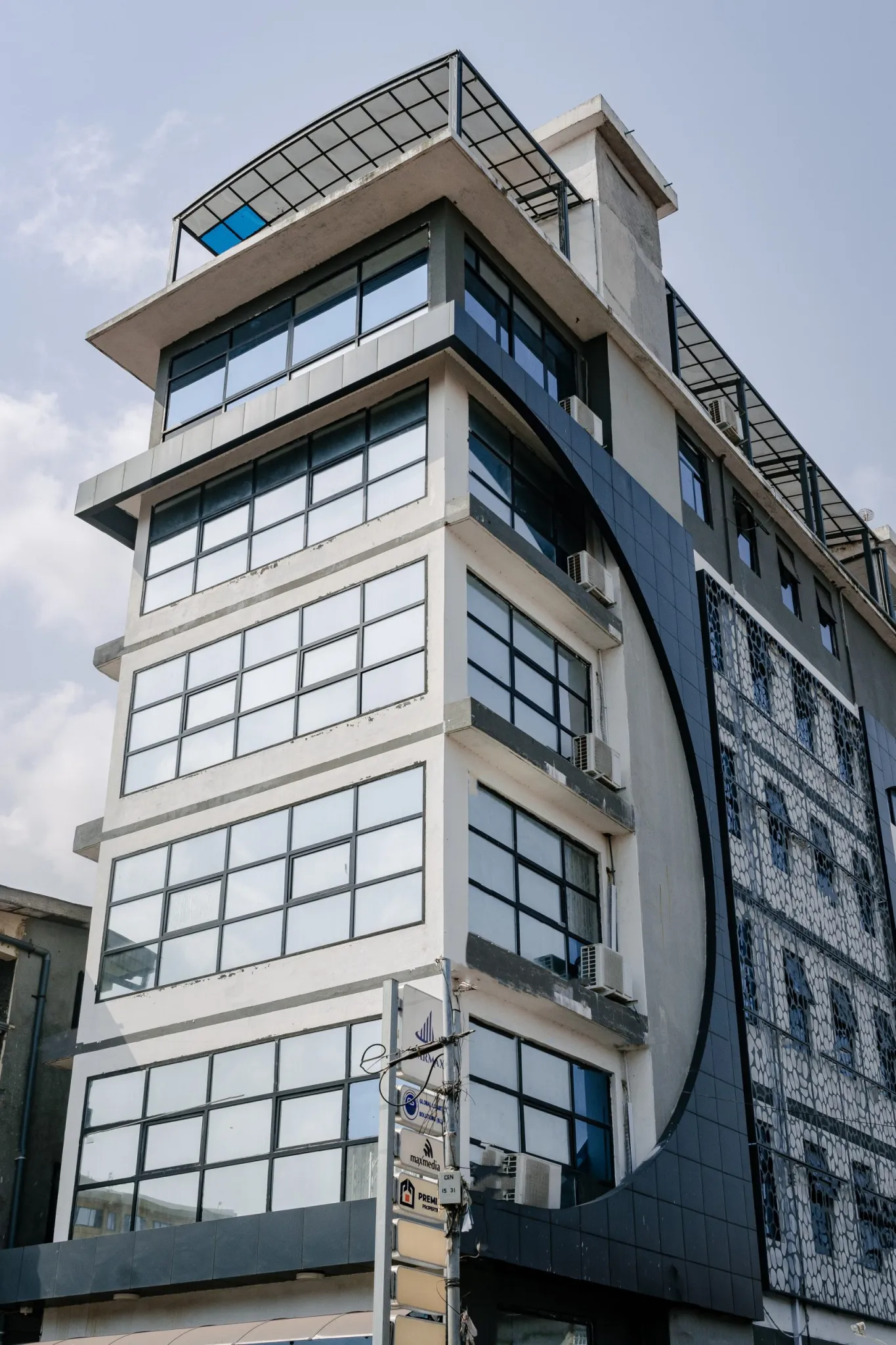 STARMAX Building - Modern commercial complex with distinctive curved architecture